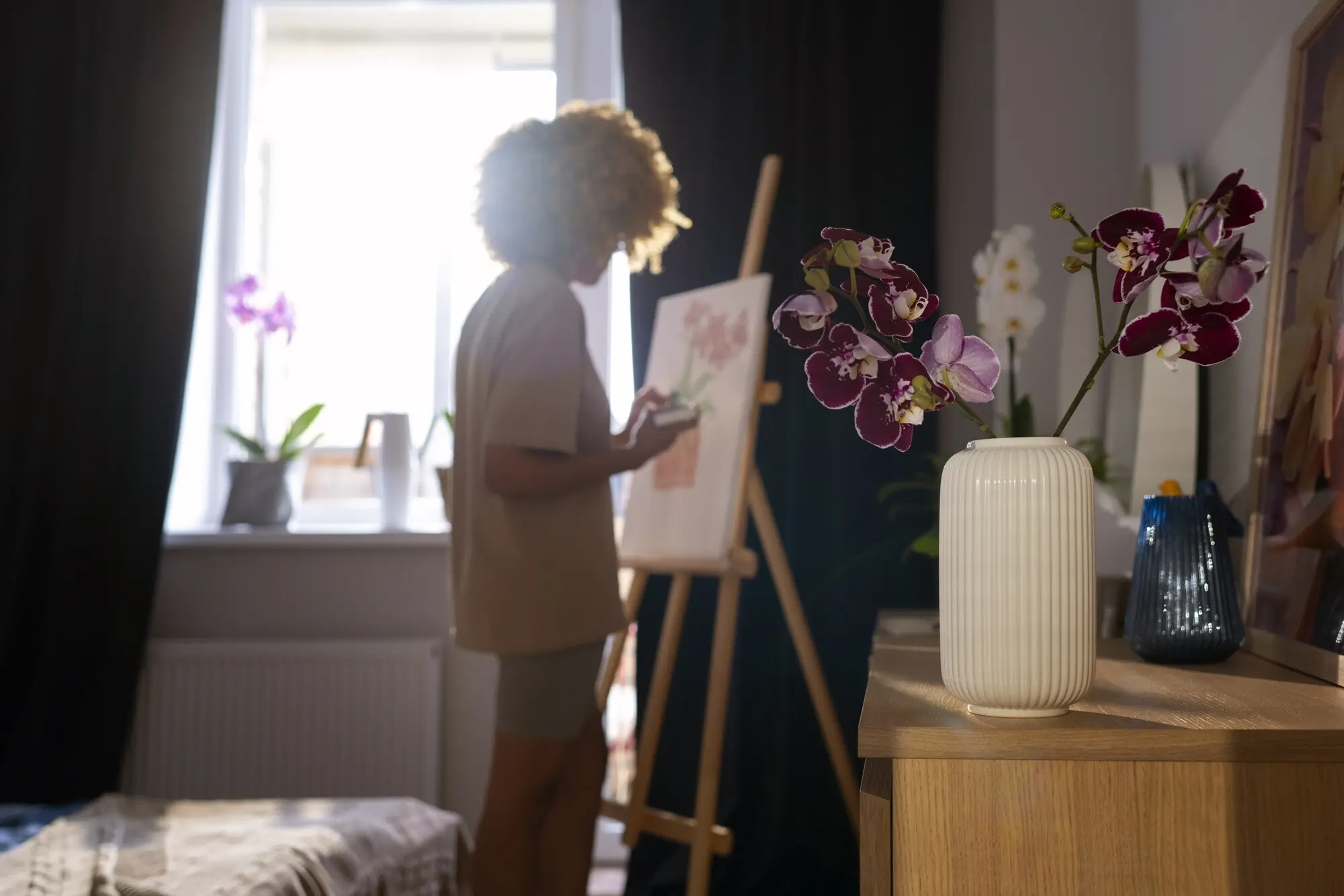 Primer plano de una mujer pintando orquídeas.
